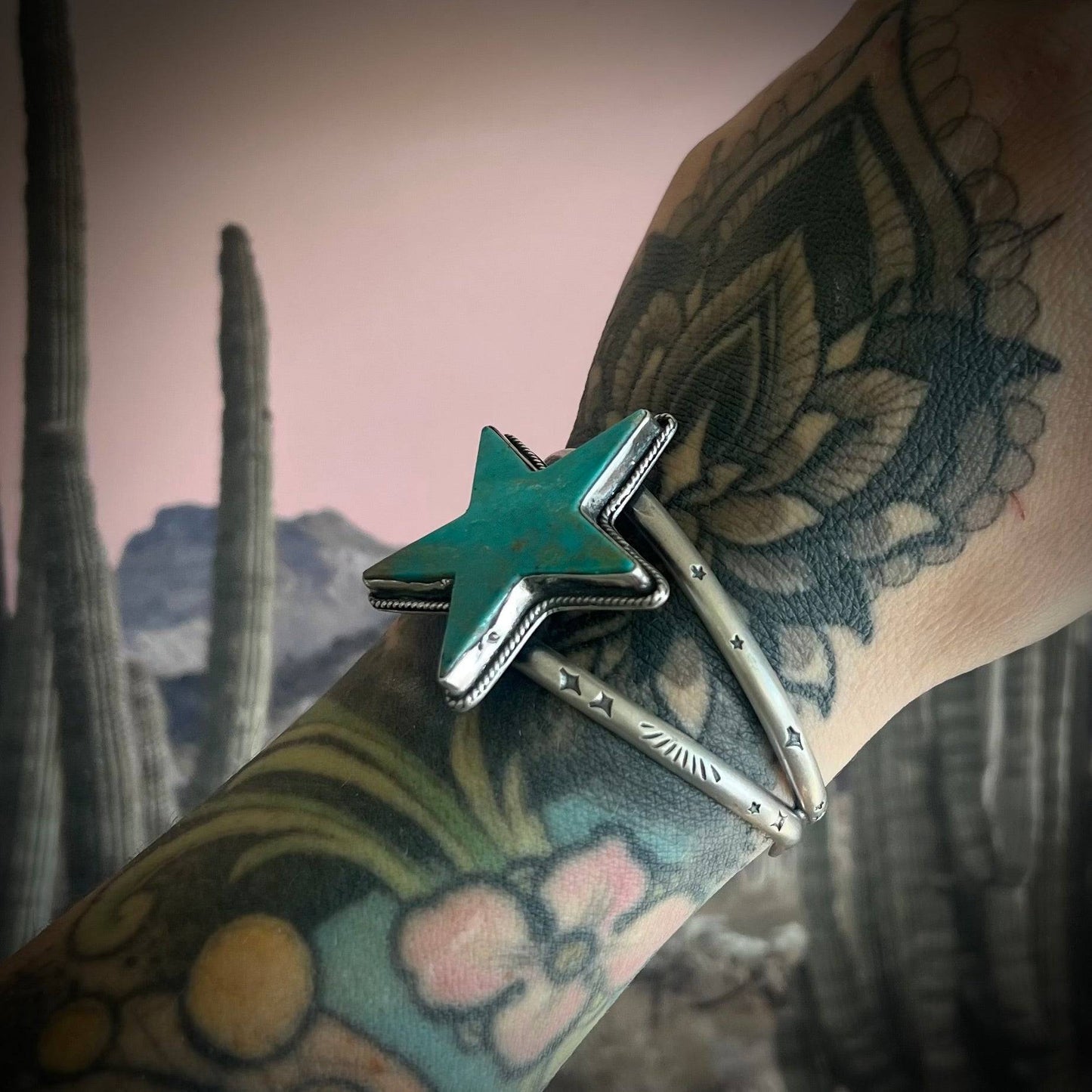 Side view of the Kingman Turquoise Statement Cuff showcasing the star-shaped turquoise stone and sterling silver band with intricate hand-stamped designs. Perfect for S/M wrists.