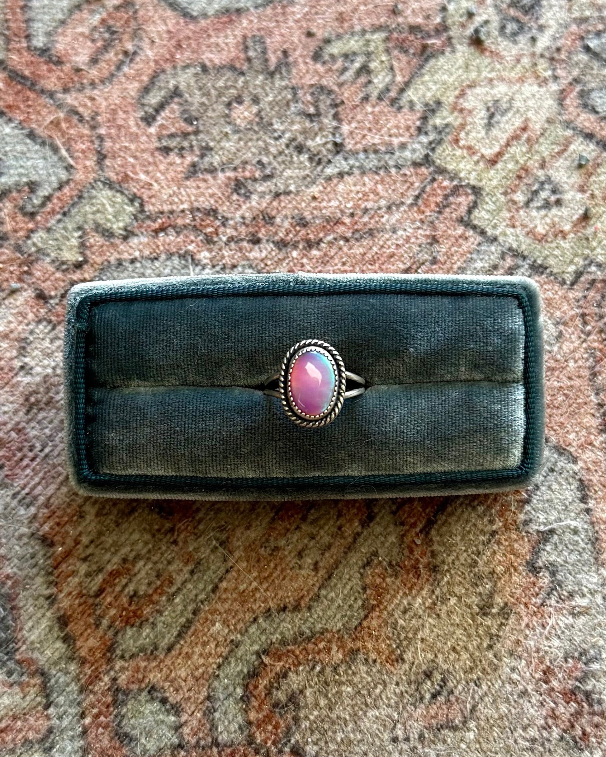 Ring on a black box on a patterned rug